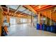 Large unfinished basement area showing framing, mechanicals, and sliding glass door access at 9832 N Crystal Lake Dr, Littleton, CO 80125