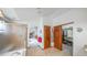 Bathroom featuring a shower, arched doorway to the main bedroom, and closet space at 9832 N Crystal Lake Dr, Littleton, CO 80125