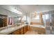 Bathroom featuring double sinks, a bathtub, a shower, and modern finishes at 9832 N Crystal Lake Dr, Littleton, CO 80125