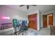 Bedroom featuring desk area, closet, and doorway leading to an adjacent room at 9832 N Crystal Lake Dr, Littleton, CO 80125