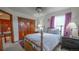 Comfortable bedroom featuring a wood bed frame, closet, and large window at 9832 N Crystal Lake Dr, Littleton, CO 80125