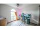Bright bedroom featuring a large window, modern desk setup, and neutral decor at 9832 N Crystal Lake Dr, Littleton, CO 80125