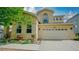 Inviting exterior showcasing a well-maintained yard and attached two car garage at 9832 N Crystal Lake Dr, Littleton, CO 80125