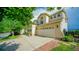 Charming home showcasing a two-car garage and manicured landscaping at 9832 N Crystal Lake Dr, Littleton, CO 80125