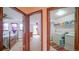 Hallway with doorways leading to a bedroom and a laundry room at 9832 N Crystal Lake Dr, Littleton, CO 80125
