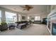 Spacious living room with large windows, plush seating, and a cozy fireplace at 9832 N Crystal Lake Dr, Littleton, CO 80125