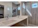 Elegant bathroom featuring a double vanity, glass-enclosed shower, and contemporary design at 5469 S Curtice St # L, Littleton, CO 80120