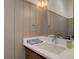 Stylish bathroom with modern fixtures, a sleek vanity, and neutral wall paneling at 5469 S Curtice St # L, Littleton, CO 80120