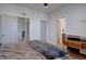 Bedroom featuring neutral decor, multiple doorways, and an adjacent bathroom at 5469 S Curtice St # L, Littleton, CO 80120