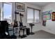 Spare bedroom showcasing guitars and artwork with a view through window blinds at 5469 S Curtice St # L, Littleton, CO 80120