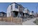 Modern townhomes showcase a mix of brick and siding with individual front patios and well-maintained landscaping at 5469 S Curtice St # L, Littleton, CO 80120