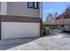 Exterior view of the two car garage with concrete driveway and alley access at 5469 S Curtice St # L, Littleton, CO 80120