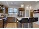 Modern kitchen with stainless steel appliances, a center island, and stylish pendant lighting at 5469 S Curtice St # L, Littleton, CO 80120