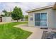 Backyard featuring a well-maintained lawn, mature tree, and a patio area with access to the house at 8481 Uinta St, Commerce City, CO 80022
