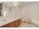 Bright bathroom features double sinks, ample countertop space, toilet, and a bathtub at 8481 Uinta St, Commerce City, CO 80022