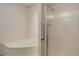 Bathroom featuring a corner tub and a shower with a glass door and white tiling at 8481 Uinta St, Commerce City, CO 80022