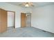 Spacious carpeted bedroom with two doors and ample closet space, plus a ceiling fan at 8481 Uinta St, Commerce City, CO 80022