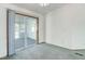This bedroom features plush carpeting and a large sliding glass door leading to a sunroom at 8481 Uinta St, Commerce City, CO 80022
