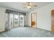 View of carpeted bedroom showing entry to the en-suite bathroom and a ceiling fan at 8481 Uinta St, Commerce City, CO 80022