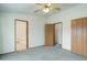 Bright bedroom featuring carpeted flooring and two doors, leading to the bathroom and closet at 8481 Uinta St, Commerce City, CO 80022