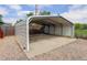 Metal carport structure with a concrete slab and gravel surroundings at 8481 Uinta St, Commerce City, CO 80022