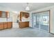 Eat-in kitchen and dining area with ample light, sliding glass doors, and wood cabinetry at 8481 Uinta St, Commerce City, CO 80022