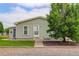 Charming single-story home exterior with green grass, a sidewalk, and ample natural light at 8481 Uinta St, Commerce City, CO 80022