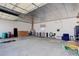 Large garage interior with overhead lighting, a storage shelf, and ample open space at 8481 Uinta St, Commerce City, CO 80022