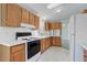 Well-equipped kitchen featuring classic wood cabinets and essential appliances at 8481 Uinta St, Commerce City, CO 80022