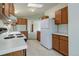 Open kitchen with white countertops, wood cabinets, and a full-sized refrigerator at 8481 Uinta St, Commerce City, CO 80022