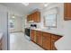Efficient kitchen featuring white countertops, wood cabinets and essential appliances at 8481 Uinta St, Commerce City, CO 80022