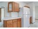 Functional kitchen with white countertops, wood cabinets, and a modern refrigerator at 8481 Uinta St, Commerce City, CO 80022
