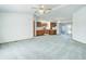 Large living room open to the kitchen featuring carpet floors, natural light, and a ceiling fan at 8481 Uinta St, Commerce City, CO 80022