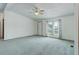 Bright living room with carpet, a ceiling fan, and a window at 8481 Uinta St, Commerce City, CO 80022