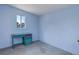The interior room is light blue and features a small desk, window, and grey carpet at 8481 Uinta St, Commerce City, CO 80022