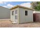 Outdoor shed featuring neutral siding, windows, and a door at 8481 Uinta St, Commerce City, CO 80022
