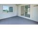 Enclosed sunroom with carpeting and a sliding glass door to the exterior at 8481 Uinta St, Commerce City, CO 80022