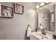 Cozy bathroom features a vanity sink with a mirror and a towel ring at 2415 E 110Th Dr, Northglenn, CO 80233