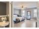 Bright bedroom featuring hardwood floors, modern ceiling fan and large windows allowing plenty of natural light at 2415 E 110Th Dr, Northglenn, CO 80233