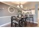 Dining room with modern lighting and open view to the kitchen at 2415 E 110Th Dr, Northglenn, CO 80233
