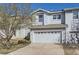 Well-maintained townhome with attached two-car garage and mature tree in the front yard at 2415 E 110Th Dr, Northglenn, CO 80233