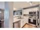 Stylish kitchen with white cabinets, stainless steel appliances, and eat-in bar at 2415 E 110Th Dr, Northglenn, CO 80233