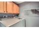 A well-equipped laundry room with overhead cabinets and a hanging rack for storage and convenience at 2415 E 110Th Dr, Northglenn, CO 80233