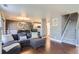 Open concept living room features hardwood floors, dining space, and stairs to the upper level at 2415 E 110Th Dr, Northglenn, CO 80233