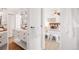 Bright bathroom featuring a sleek vanity with marble countertop and a glimpse of a beautifully decorated bedroom at 6110 E 6Th Avenue Pkwy, Denver, CO 80220