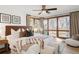 Bright bedroom features a large window, hardwood floors, and modern decor elements at 6110 E 6Th Avenue Pkwy, Denver, CO 80220