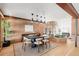 Open concept dining room with a modern table, brick walls, stylish lighting, and hardwood floors at 6110 E 6Th Avenue Pkwy, Denver, CO 80220