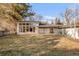 Modern home with large windows offering natural light, complemented by a well-maintained lawn and mature trees at 6110 E 6Th Avenue Pkwy, Denver, CO 80220