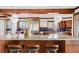 Bright kitchen with wood cabinets, a concrete island, stainless steel appliances, and stylish pendant lights at 6110 E 6Th Avenue Pkwy, Denver, CO 80220