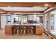 Spacious kitchen boasting wood cabinets, stainless steel appliances, and a large island with bar seating at 6110 E 6Th Avenue Pkwy, Denver, CO 80220